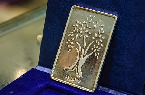 A silver bar is displayed at a bullion shop. 