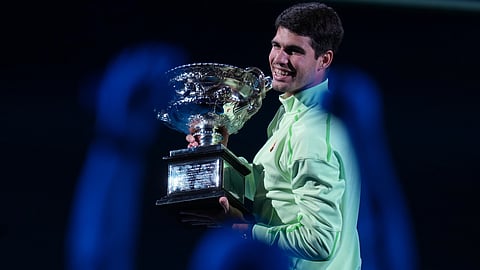 Carlos Alcaraz of Spain holds the Norman Brookes Challenge Cup after defeating Novak Djokovic of Serbia in the men's singles final at the Australian Open tennis championship in Melbourne, Australia, Sunday, Feb. 1, 2026 