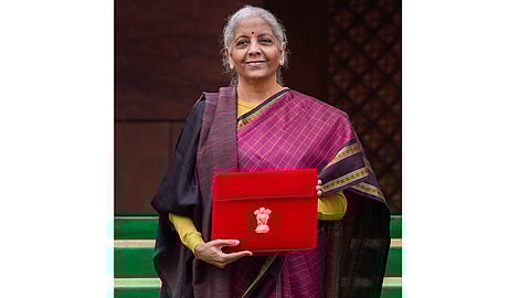 Finance Minister Nirmala Sitharaman shows the digital tablet, enclosed in a traditional red 'bahi-khata' style pouch, at the Parliament premises before presenting of the 'Union Budget 2026-27', in New Delhi, Sunday, Feb. 1, 2026
