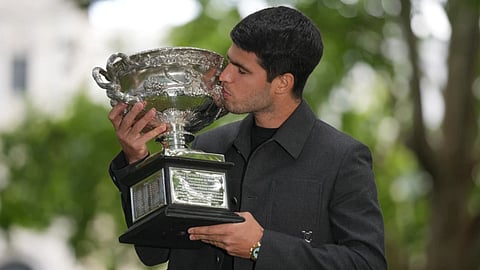 Carlos Alcaraz of Spain kisses the Norman Brookes Challenge Cup the morning after defeating Novak Djokovic of Serbia in the men's singles final at the Australian open tennis championship, in Melbourne, Australia.