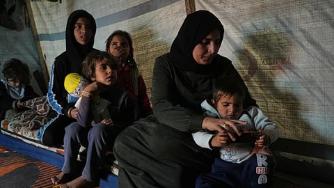 Rotana al-Regeb, who was allowed into Gaza from Egypt following the long-awaited reopening of the Rafah border crossing, reunites with her children in KhanYounis, southern Gaza Strip