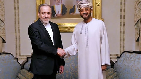In this photo released by the Iranian Foreign Ministry, Iranian Foreign Minister Abbas Araghchi, left, shakes hands with his Omani counterpart Sayyid Badr Albusaidi during their meeting prior to Iran and the U.S. negotiations, in Muscat, Oman, Friday, Feb. 6, 2026.