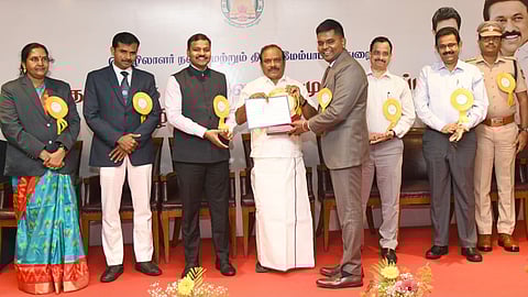 Labour Welfare Minister presenting a planque and letter of appreciation to Kishan Kumar IAS, sub-district collector, Chidambaram, for his work in rescue and rehab of bonded labourers