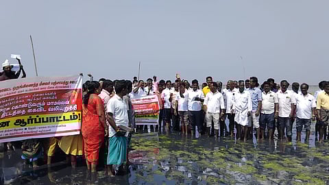 Members of the fishing community and residents standing in
the Kovalam wetlands near Vada Nemmeli village on Monday 