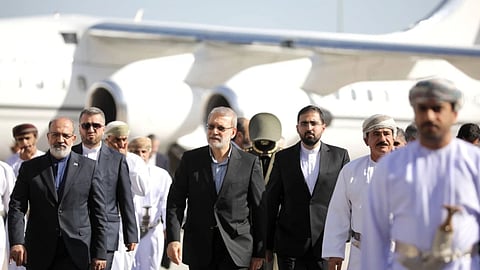 In this photo released by Iran's Supreme National Security Council office, Secretary of the Supreme National Security Council Ali Larijani, center, arrives in Muscat, Oman, on February 10, 2026