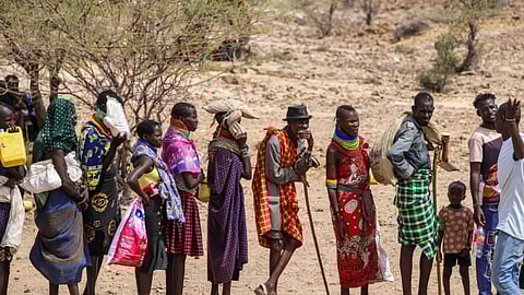 Locals queue to receive relief food as severe drought continues, in Lomekulu Village, Turkana County, Kenya