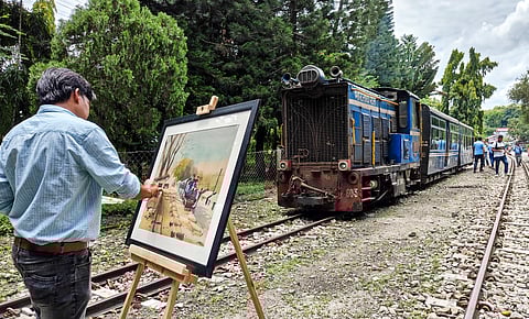 An artist makes a painting of Darjeeling Himalayan Railway, also known as Toy Train, to mark the 144th anniversary of its establishment, at Sukna railway station, on the outskirts of Siliguri, West Bengal, Friday, July 4, 2025.