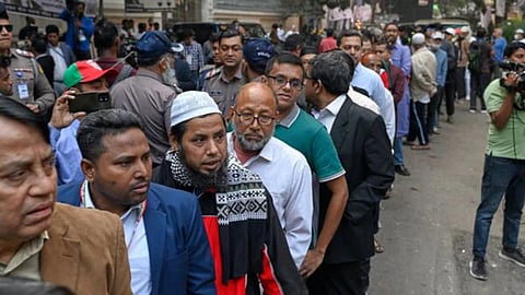 Voters wait in line outside a polling center to cast their ballots during the national parliamentary elections in Dhaka, Bangladesh, Thursday, Feb. 12, 2026.