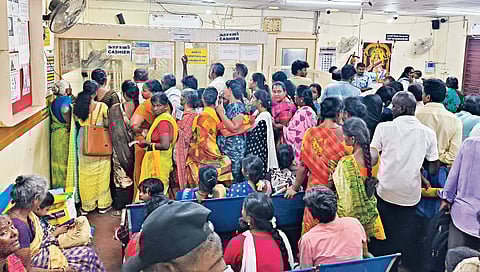Women line up at a bank in Theni to withdraw the KMUT money