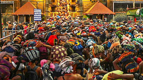 Rush of people as they wait to offer prayers at the Sabarimala temple ahead of the 'Makaravilakku' festival, in Pathanamthitta district, Kerala, 