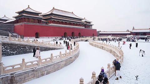 Tourists visit a snow-covered Forbidden City in Beijing, China