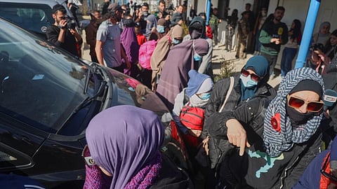 Family members of suspected Islamic State militants who are Australian nationals walk toward a van bound for the airport in Damascus during the first repatriation operation of the year at Roj Camp in eastern Syria