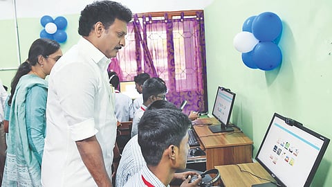 Minister Poyyamozhi listening a student explain the function of a high-tech lab on Friday