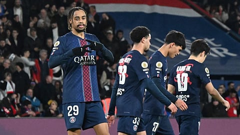 PSG's Bradley Barcola, left, celebrates after scoring his side's second goal during the French League One soccer match between Paris Saint-Germain and Metz in Paris, France.