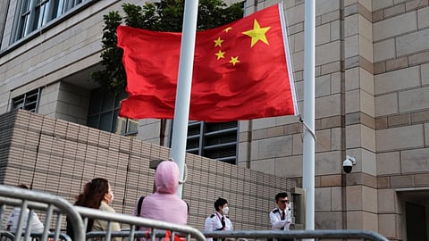 Staff members of the West Kowloon Magistrates' Courts raise a China national flag outside West Kowloon Law Courts Building ahead of the national security
appeal cases, in Hong Kong