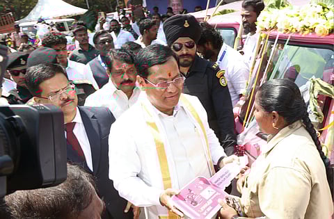 Minister for Ports, Shipping and Waterways Sarbananda Sonowal presents an auto to a fisherwoman as part of VOC Port's welfare assistance on Monday
