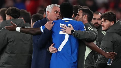 Real Madrid's Vinicius Junior argues with Benfica's head coach José Mourinho after scoring the opening goal during a Champions League playoff soccer match between SL Benfica and Real Madrid in Lisbon, Portugal.