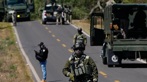 A soldier clears a roadblock on a road leading to Tapalpa, Mexico, Monday, Feb. 23, 2026, a day after the Mexican army killed Jalisco New Generation Cartel leader Nemesio Oseguera Cervantes, known as “El Mencho.” 