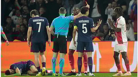 Monaco's Mamadou Coulibaly receives a red card during a Champions League second leg playoff soccer match between Paris Saint-Germain and Monaco in Paris Wednesday, Feb. 25, 2026.