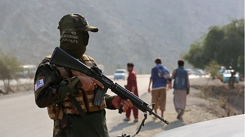 An Afghan Taliban soldier stands in guard on the Afghan side of Torkham border crossing with Pakistan in Torkham