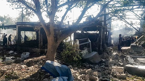 Security personnel and locals inspect the damaged premises after a blast at an explosives manufacturing factory, in Nagpur district