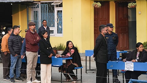 Polling officials check voters identity cards during voting in the Nepal general elections, in Kathmandu