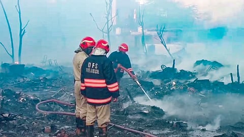 People look through charred remains after a massive fire broke out in a cluster of shanties, gutting more than 50 huts, in the Rithala area, New Delhi, Thursday, March 5, 2026