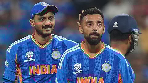 Spectators cheer as India's Varun Chakravarthy celebrates after dismissing England's Jos Buttler during the ICC Men's T20 World Cup 2026 second semifinal cricket match between India and England at Wankhede Stadium, in Mumbai, Thursday, March 5, 2026