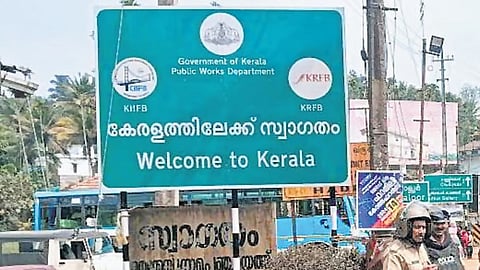 Notice board with a sign welcome to Kerala in the border of Tamil Nadu.