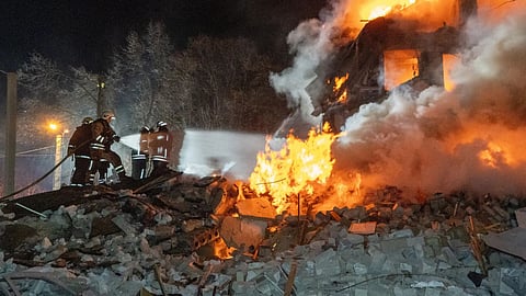 Firefighters put out the fire in an multi-storey apartment building following a Russian missile attack in Kharkiv, Ukraine