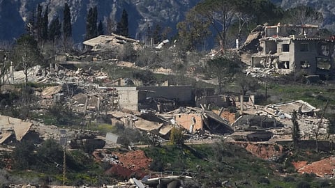 An Israeli tank maneuvers in southern Lebanon near the border with Israel
