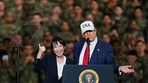 Japanese Prime Minister Sanae Takaichi gestures as U.S. President Donald Trump delivers his speech during their visit to the aircraft carrier USS George Washington at the U.S. Navy’s Yokosuka base in Yokosuka, south of Tokyo, on Oct. 28, 2025