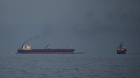 Oil tankers and cargo ships line up in the Strait of Hormuz as seen from Khor Fakkan, United Arab Emirates.