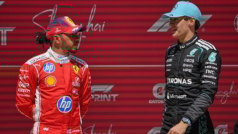 Winner Mercedes driver George Russell, right, of Britain talks with third placer Ferrari driver Lewis Hamilton of Britain after the Sprint Race of the Chinese Formula One Grand Prix at the Shanghai International Circuit, in Shanghai, China
