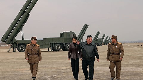 In this photo provided by the North Korean government, its leader Kim Jong Un, center right, and his daughter, center left, attend a live-fire test of multiple rocket launch systems, at an undisclosed place in North Korea Saturday, March 14, 2026. 