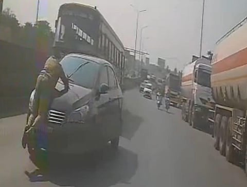 Video image of the cop clinging to the car. 