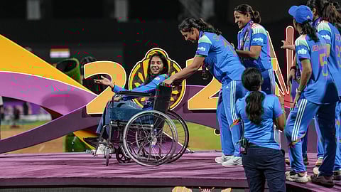 Smriti Mandhana brings teammate Pratika Rawal on a wheelchair as the team arrive to receive winning medals during the presentation ceremony after winning the ICC Women's World Cup 2025, at the DY Patil Stadium