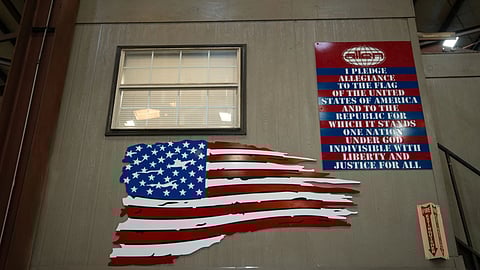 An American flag and the Pledge of Allegiance is seen inside the Allen Engineering Corporation plant, in Paragould, Ark