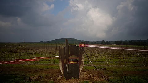 Fragment of a missile fired from Iran, and intercepted by Israeli defense system, sticks out in a open field in the Israeli-controlled Golan Heights