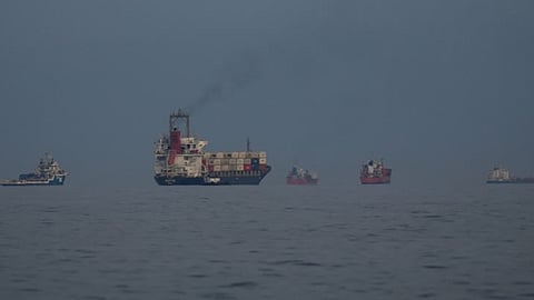 Oil tankers and cargo ships line up in the Strait of Hormuz as seen from Khor Fakkan, United Arab Emirates