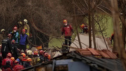 Rescue teams and firefighters search the site where two residential buildings collapsed in Istanbul