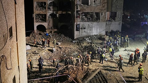 Israeli security forces and rescue teams work at the site struck by an Iranian missile in Arad, southern Israel
