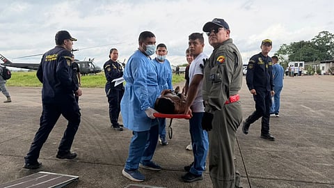 In this photo distributed by Colombia’s Armed Forces press office, people who were injured on a military cargo plane that crashed shortly after take off are loaded on to another military plane to evacuate them for treatment, from Puerto Leguizamo, Colombia, Monday, March 23, 2026