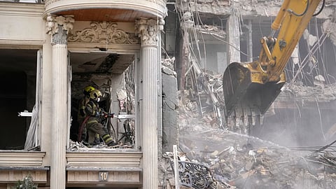 Rescue workers and first responders work at a residential building hit in an earlier U.S.-Israeli strike in Tehran, Iran