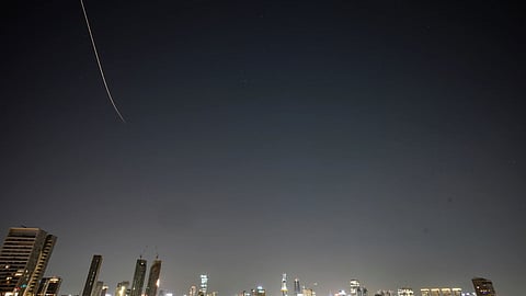 Missiles launched from Iran streak across the sky over central Israel, early Tuesday, March 24, 2026.