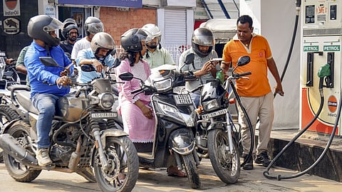 People queue up at a petrol pump amid rumours of fuel shortage in the wake of the West Asian conflict