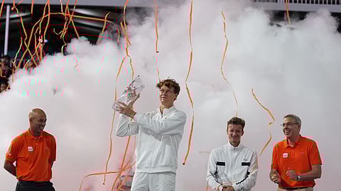 Jannik Sinner of Italy, center, hosts the Butch Buchholz trophy after defeating Jiri Lehecka of the Czech Republic, second right, in the men's singles final at the Miami Open tennis tournament, in Miami Gardens, Fla