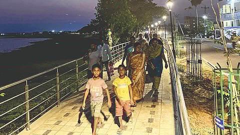 Families with children walking on the pathway created along the lake on Sunday