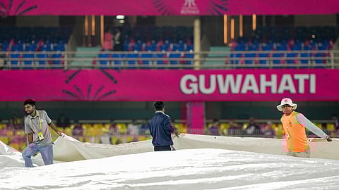 Ground staff covers the pitch during rain, before an Indian Premier League (IPL) 2026 T20 cricket match between Rajasthan Royals and Chennai Super Kings, at ACA Stadium, Barsapara, in Guwahati, Assam, Monday, March 30, 2026 