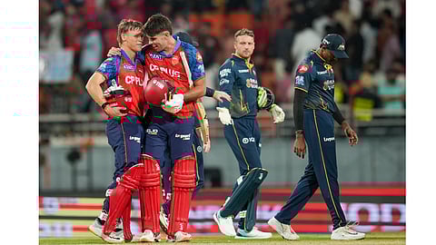 Punjab Kings' Cooper Connolly, left, and Xavier Bartlett, second left, celebrate after winning an Indian Premier League (IPL) 2026 T20 cricket match between Punjab Kings and Gujarat Titans, in Mullanpur, Tuesday, March 31, 2026.